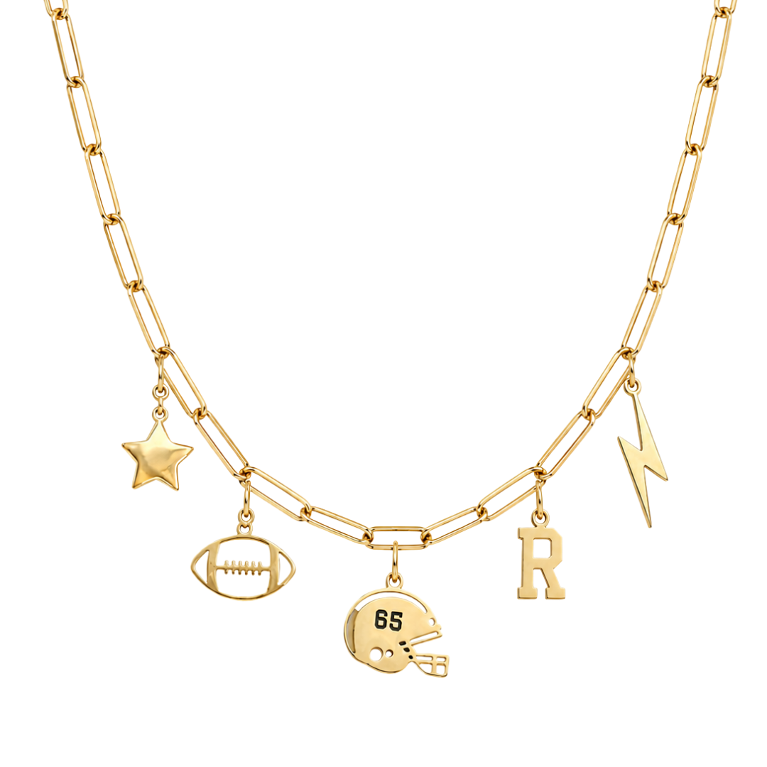 A gold-toned double-strand necklace featuring football-themed charms, including a star, football, helmet with '85' on it, lightning bolt, and letter 'R', displayed on a clean white background.