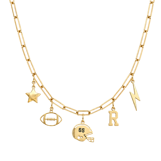 A gold-toned double-strand necklace featuring football-themed charms, including a star, football, helmet with '85' on it, lightning bolt, and letter 'R', displayed on a clean white background.